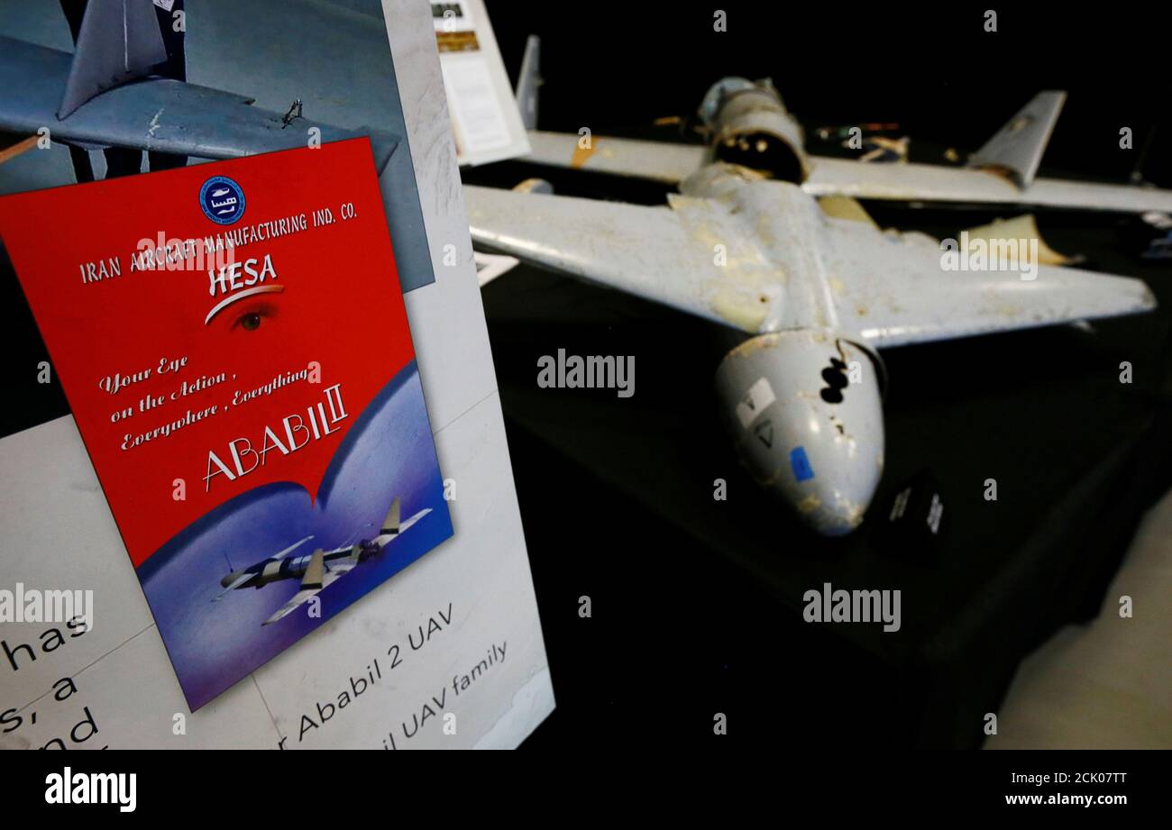A U.S. Department of Defense display shows an advertisement for Ababil II drones manufactured by the Iran Aircraft Manufacturing Company next to a drone that the Pentagon says was recovered in Yemen on display at a military base in Washington, U.S., December 13, 2017. Picture taken December 13, 2017. REUTERS/Jim Bourg Stock Photo