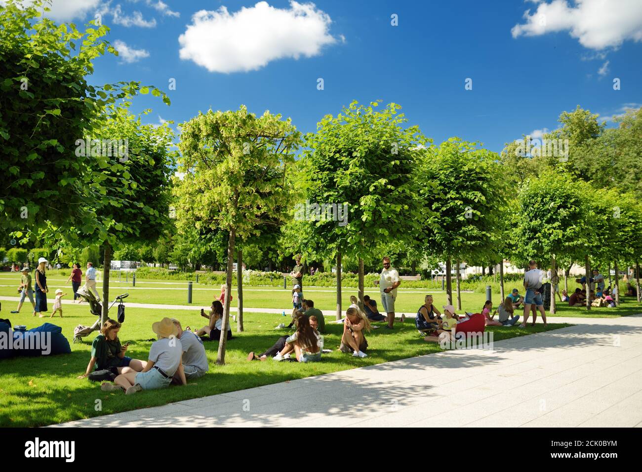 VILNIUS, LITHUANIA - JULY 14, 2020: People having fun on newly renovated Lukiskes square in Vilnius. Sunny summer day in UNESCO-inscribed Old Town of Stock Photo