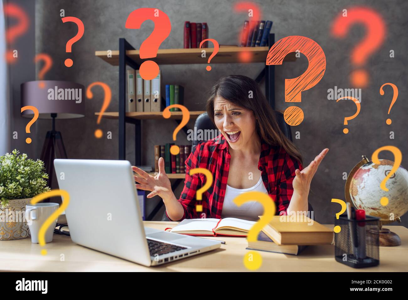Girl is is Smartworking and works at home and has a lot of questions Stock Photo