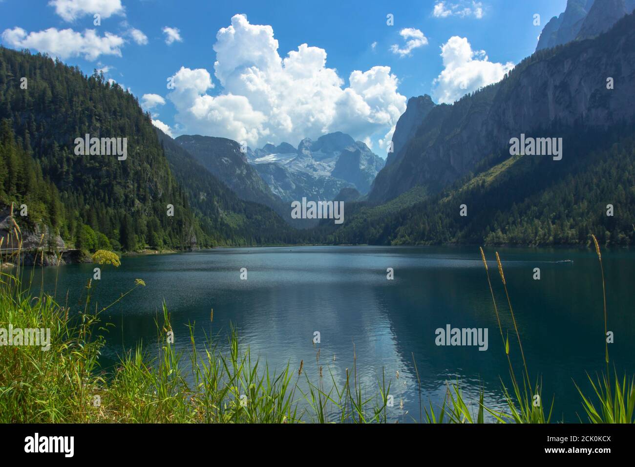 View of majestic mountains and lake.Nature getaway. Turquoise water of Gosau See,lake,Austria,Dachstein glacier in background.Vacation travel scene. Stock Photo