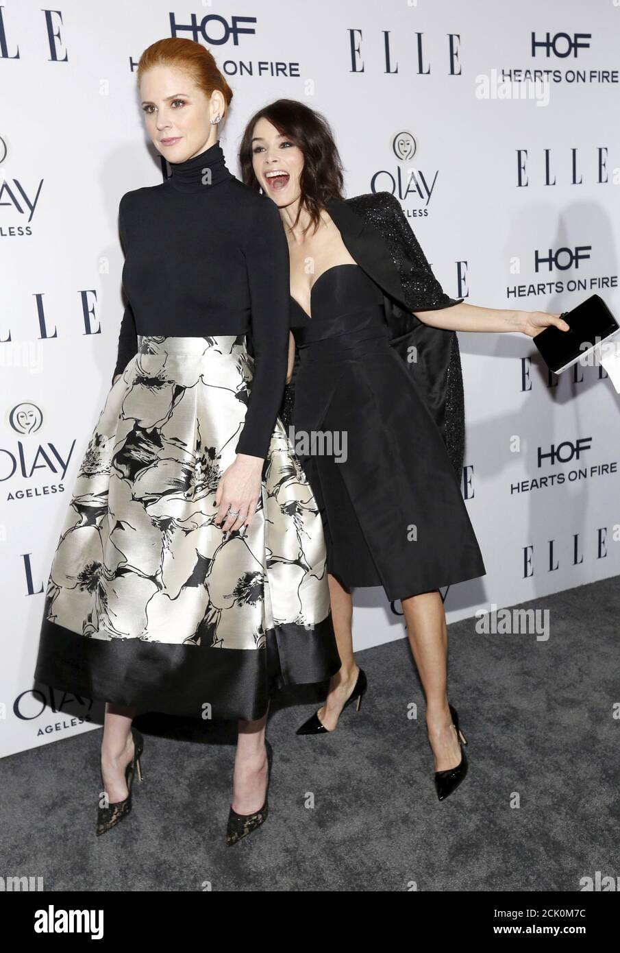 Actress Abigail Spencer (R) poses behind actress Sarah Rafferty at ELLE