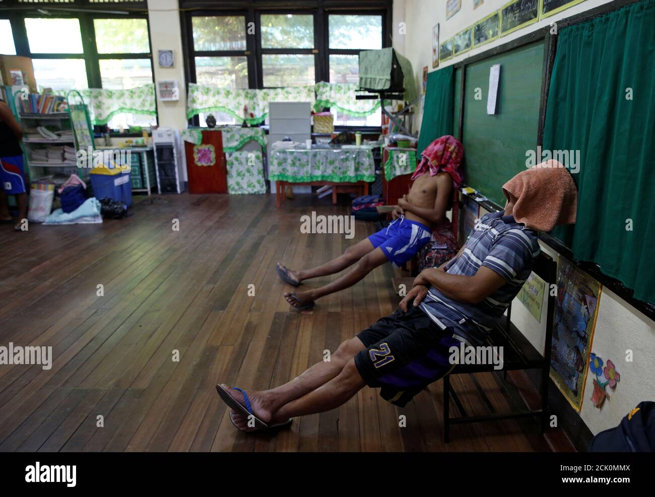 Drug users who call themselves "Recovering Champions" take a rest inside a  classroom turned into a makeshift dormitory during a weekend drug  rehabilitation program organised by the government of San Fernando, La