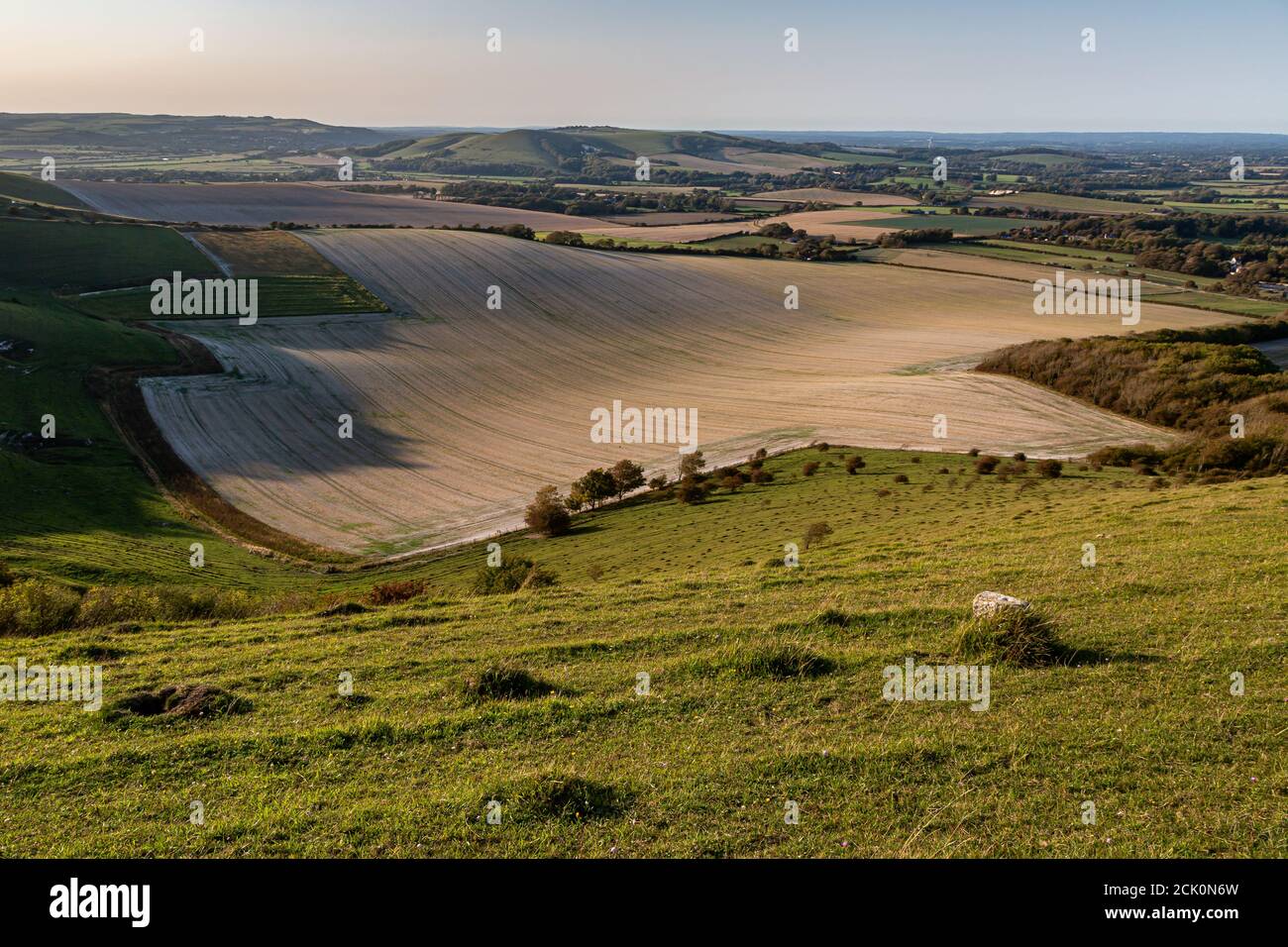 Looking out over farmland from Firle Beacon, on a sunny late summer evening Stock Photo