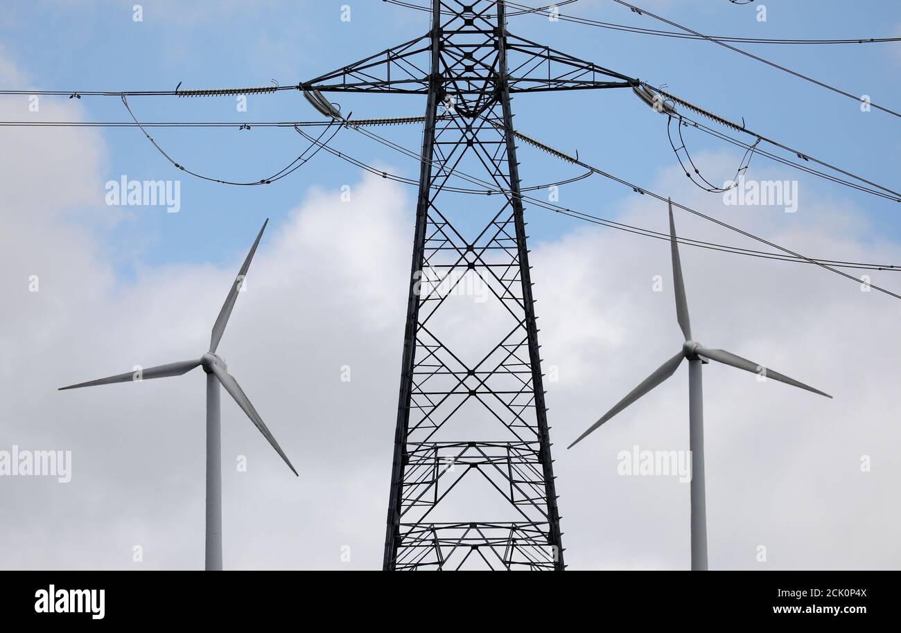 Wind Turbines Used To Generate Electricity Are Seen Underneath An Electricity Pylon In El Palo Summit Near Pola De Allande Northern Spain August 9 17 Reuters Paul Hanna Stock Photo Alamy