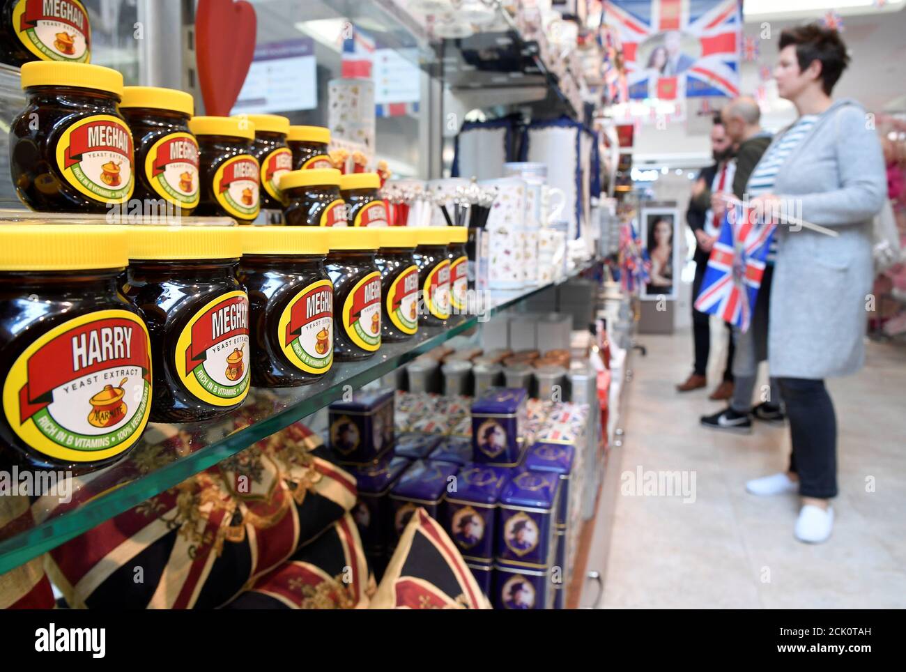 A woman browses near a shelf display with Marmite spread with a redesigned  label for the forthcoming wedding of Britain's Prince Harry and his fiancee  Meghan Markle in Windsor, Britain, May 16,