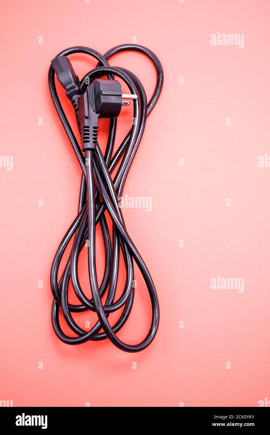Vertical closeup of a power cable on a pink background Stock Photo Alamy