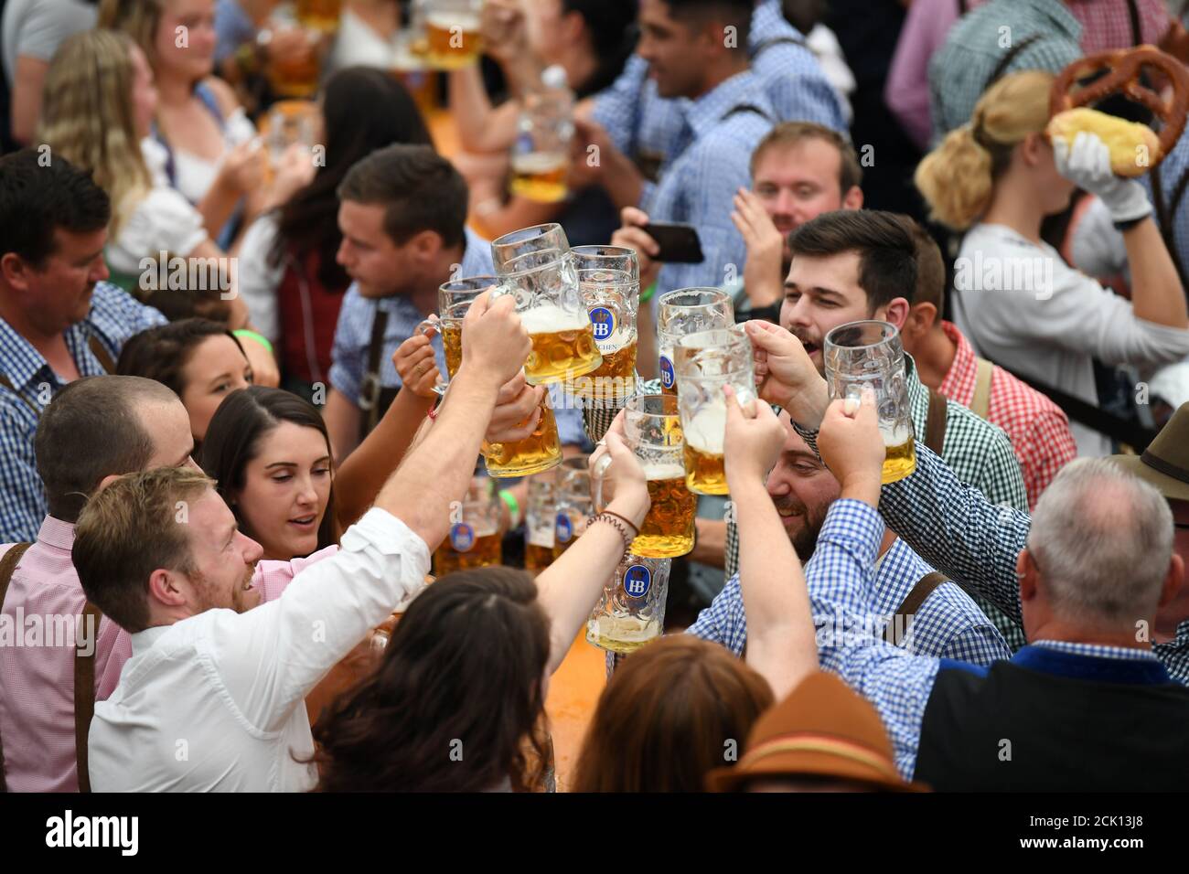 Visitors cheer with beers in a tent during Oktoberfest in Munich, Germany, September 22, 2019. REUTERS/Andreas Gebert Stock Photo