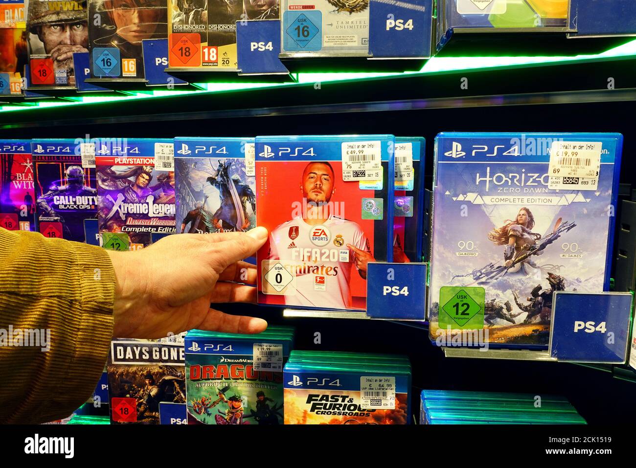 Store display filled with PlayStation 4 games for a home video game console. Stock Photo