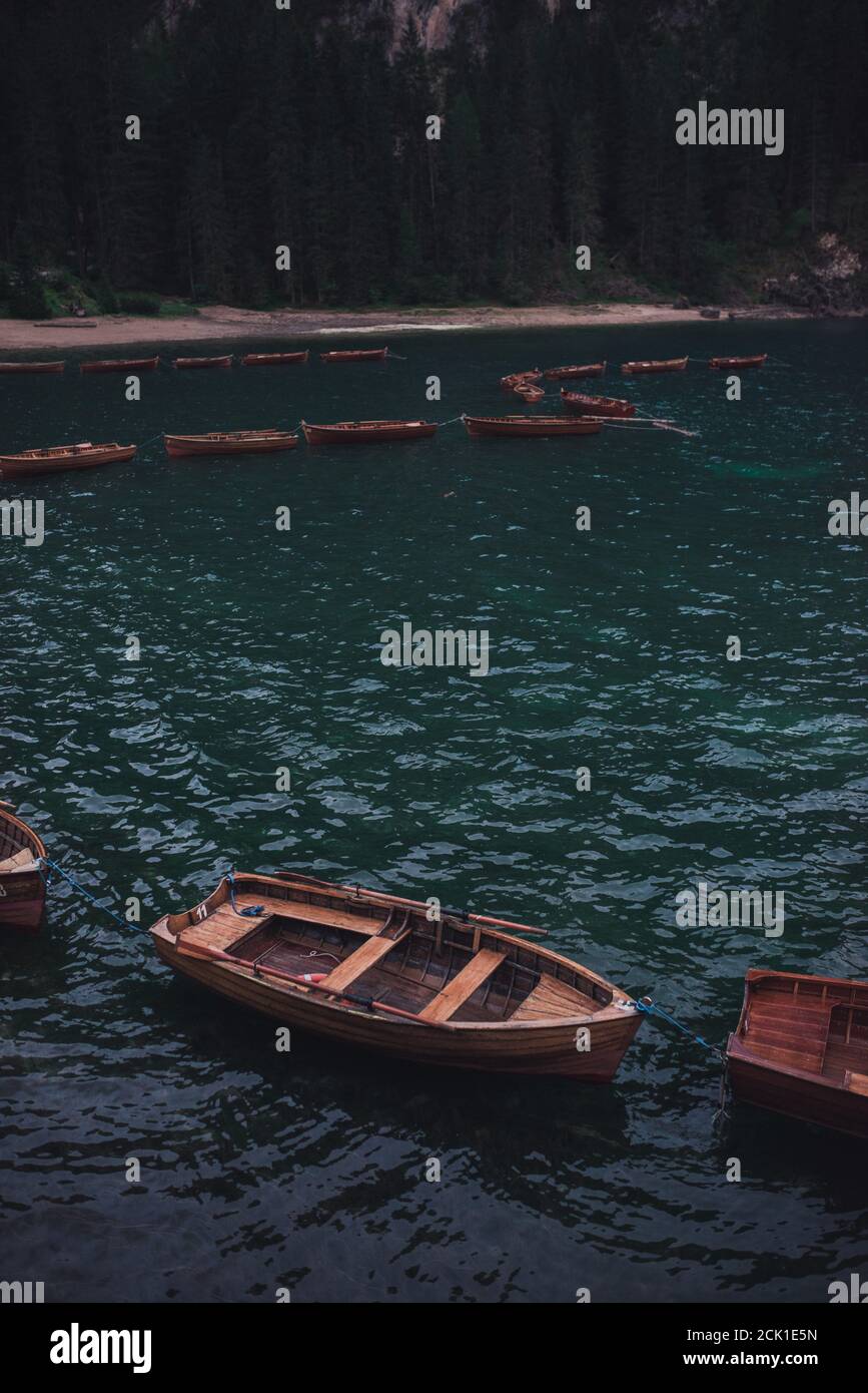 brown wooden boats stand on the alpine lake Lago di Braies Stock Photo ...
