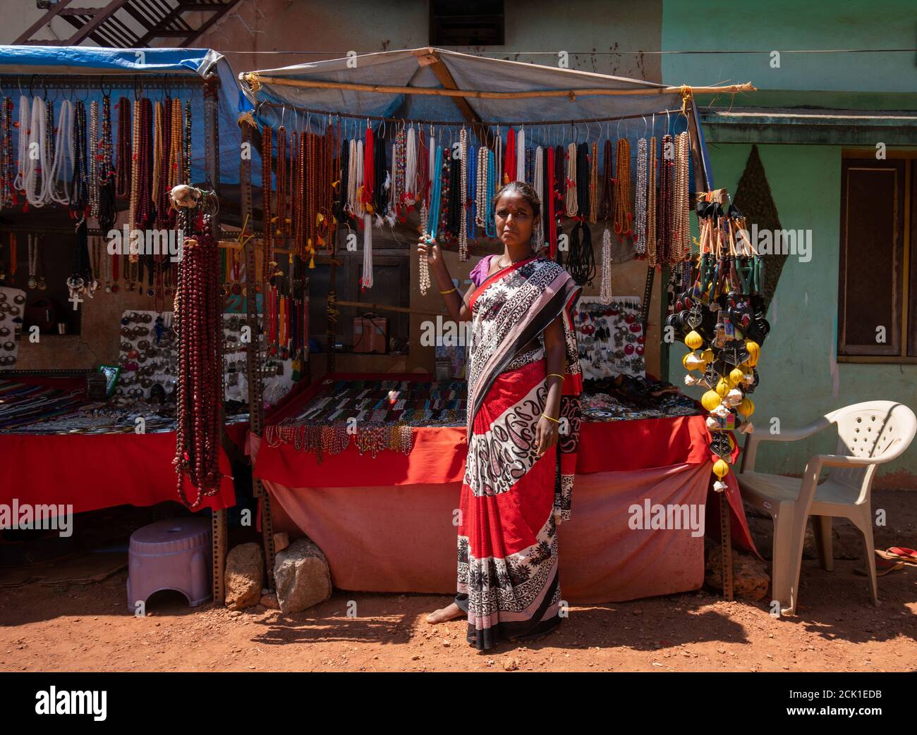 02/18/2019 Gokarna India. jewelry saleswoman in Sari ( traditional women's clothing in the Indian subcontinent),  in sunny day . Street of Gokarna. Ch Stock Photo