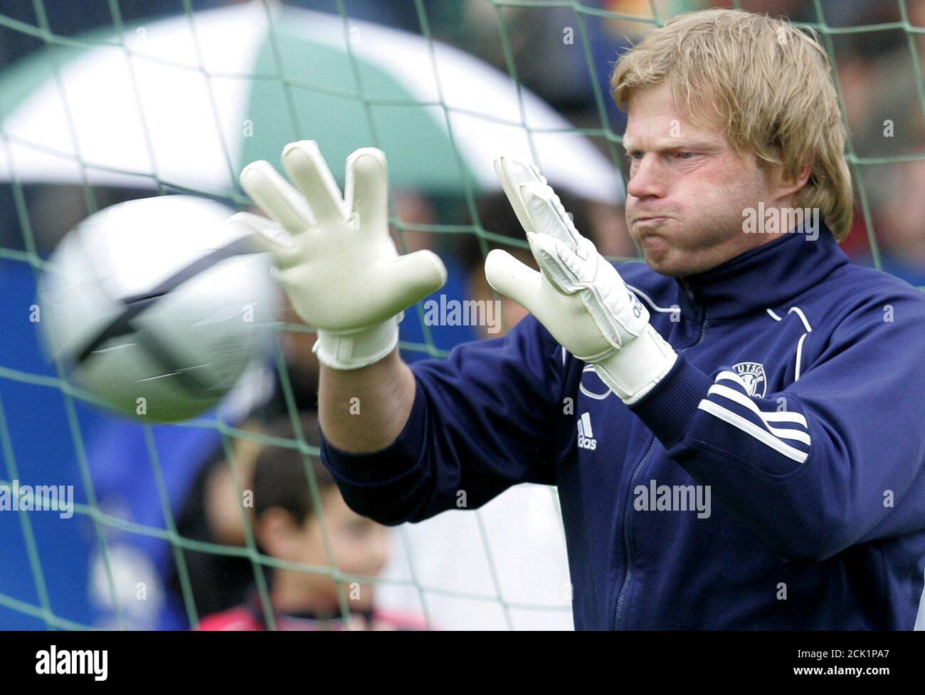 Oliver Kahn, goalkeeper of Germany's national soccer team, catches a ball  during a training session in Winden June 1, 2004. Goalkeeper and captain  Kahn became the latest Germany player to make headlines