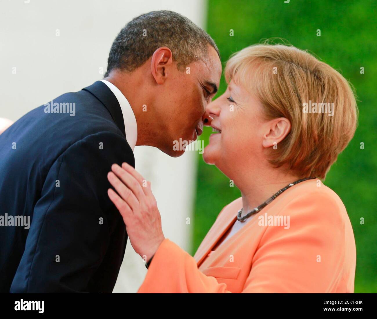 U.S. President Barack Obama embraces German Chancellor Angela Merkel outside the Chancellery in Berlin, June 19, 2013. Obama will unveil plans for a sharp reduction in nuclear warheads in a landmark speech at the Brandenburg Gate on Wednesday that comes 50 years after John F. Kennedy declared 'Ich bin ein Berliner' in a defiant Cold War address.     REUTERS/Thomas Peter (GERMANY  - Tags: POLITICS) Stock Photo