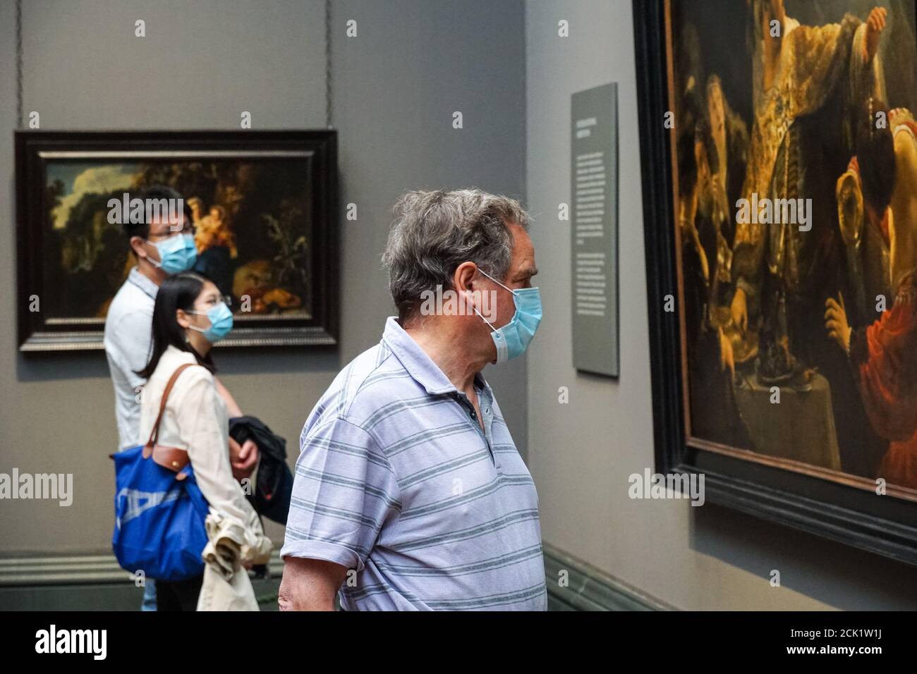 Visitors wearing face mask looking at paintings at the National Gallery in London, England United Kingdom UK Stock Photo