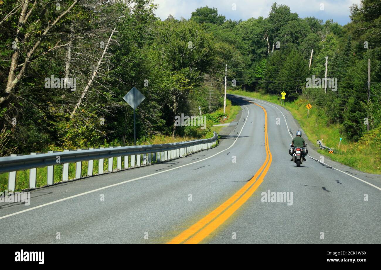 A motorcycle and cars on Vermont Route 100 near Wilmington.Vermont.USA Stock Photo