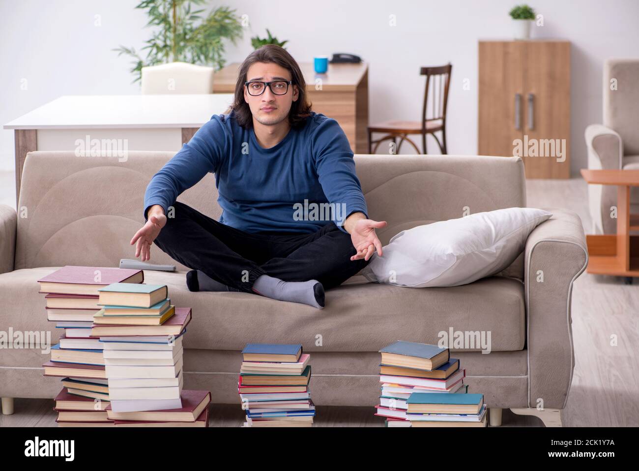 Young student preparing for exams at home Stock Photo - Alamy