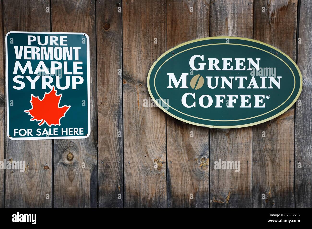 The signboards of Pure Vermont Maple Syrup For Sale Here and Green Mountain Coffee on a wooden wall.Vermont.USA Stock Photo