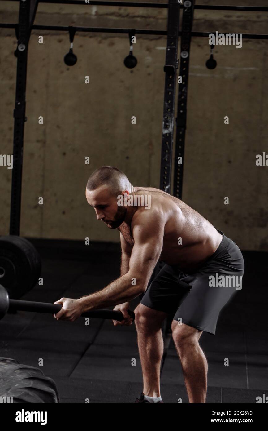 sledgehammer blow concept. personal trainer is showing exercises with