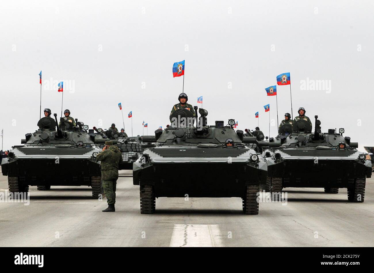 Servicemen of armed forces of self-proclaimed Luhansk People's Republic  (LPR) ride armored personnel carriers (APC) at the 5th anniversary of  creation of armed forces, at the airfield in Luhansk, Ukraine October 6,
