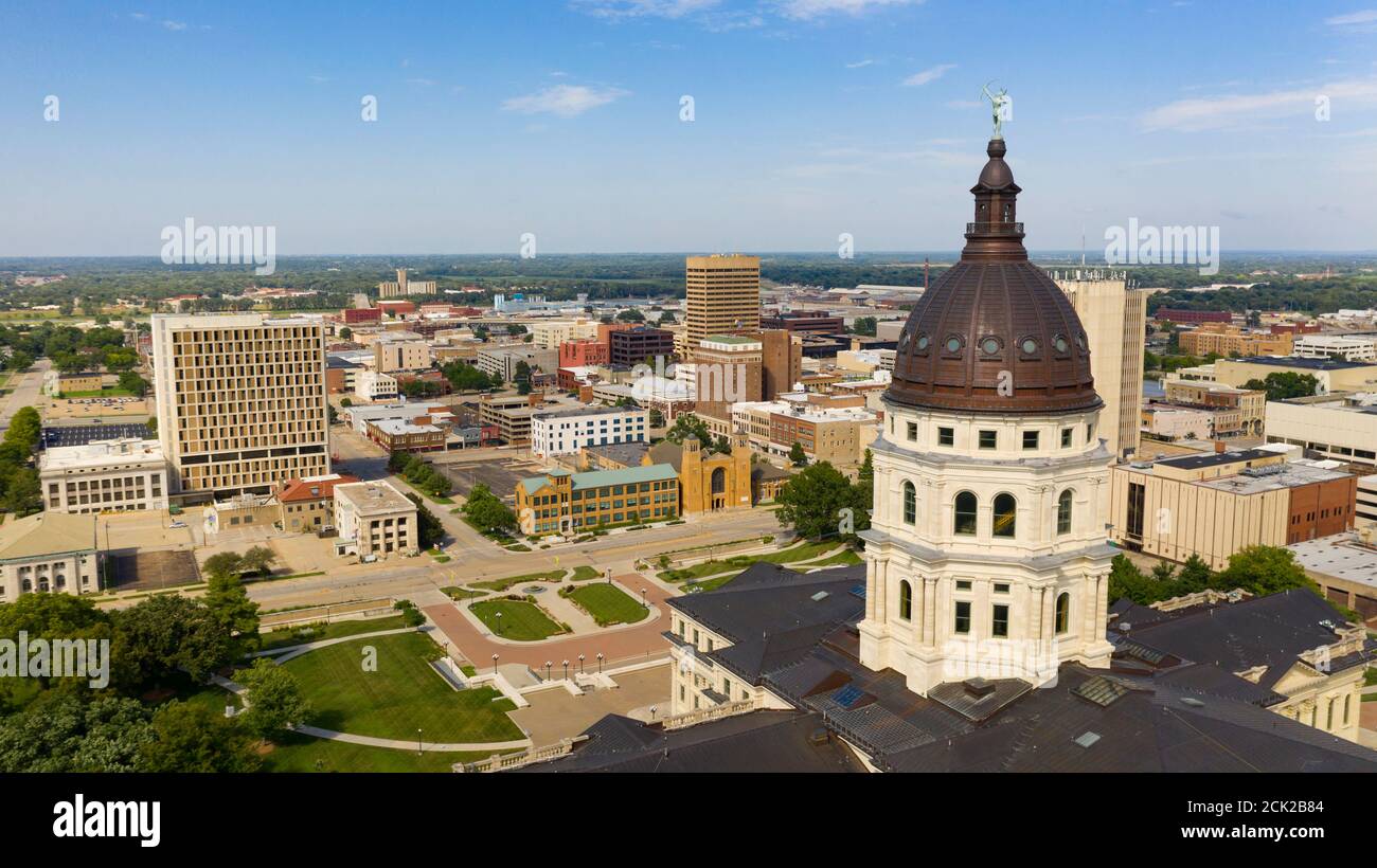 The copper dome shines in the urban area at the capitol building of Topeka Kansas Stock Photo