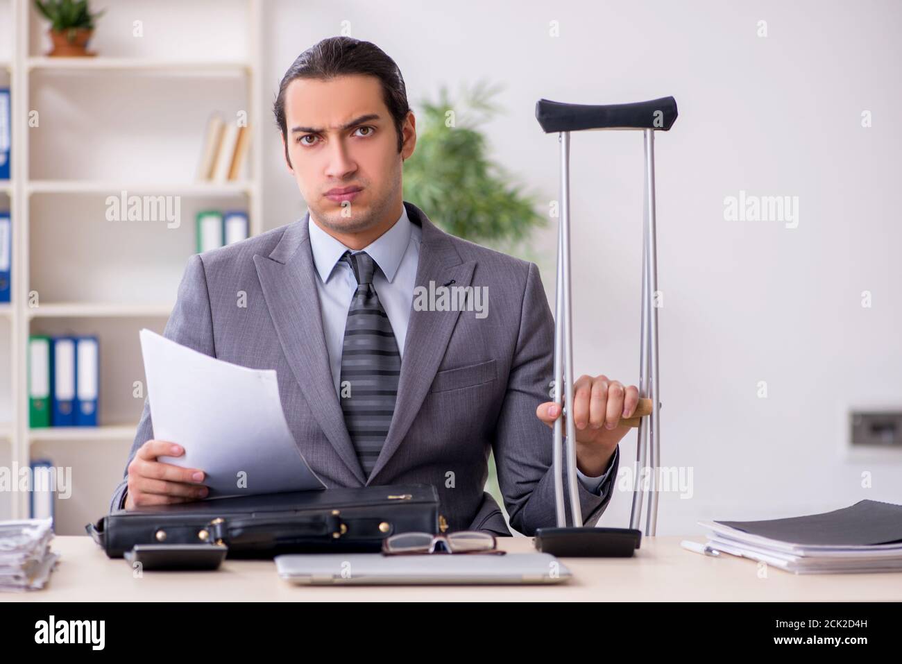 Young employee after accident at workplace Stock Photo