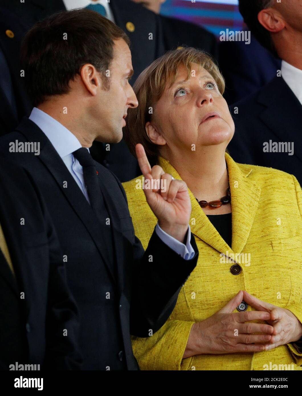 German Chancellor Angela Merkel talks with French President Emmanuel Macron  as they look at a drone during a leaders photograph at the European Union  leaders summit in Brussels, Belgium December 14, 2017.