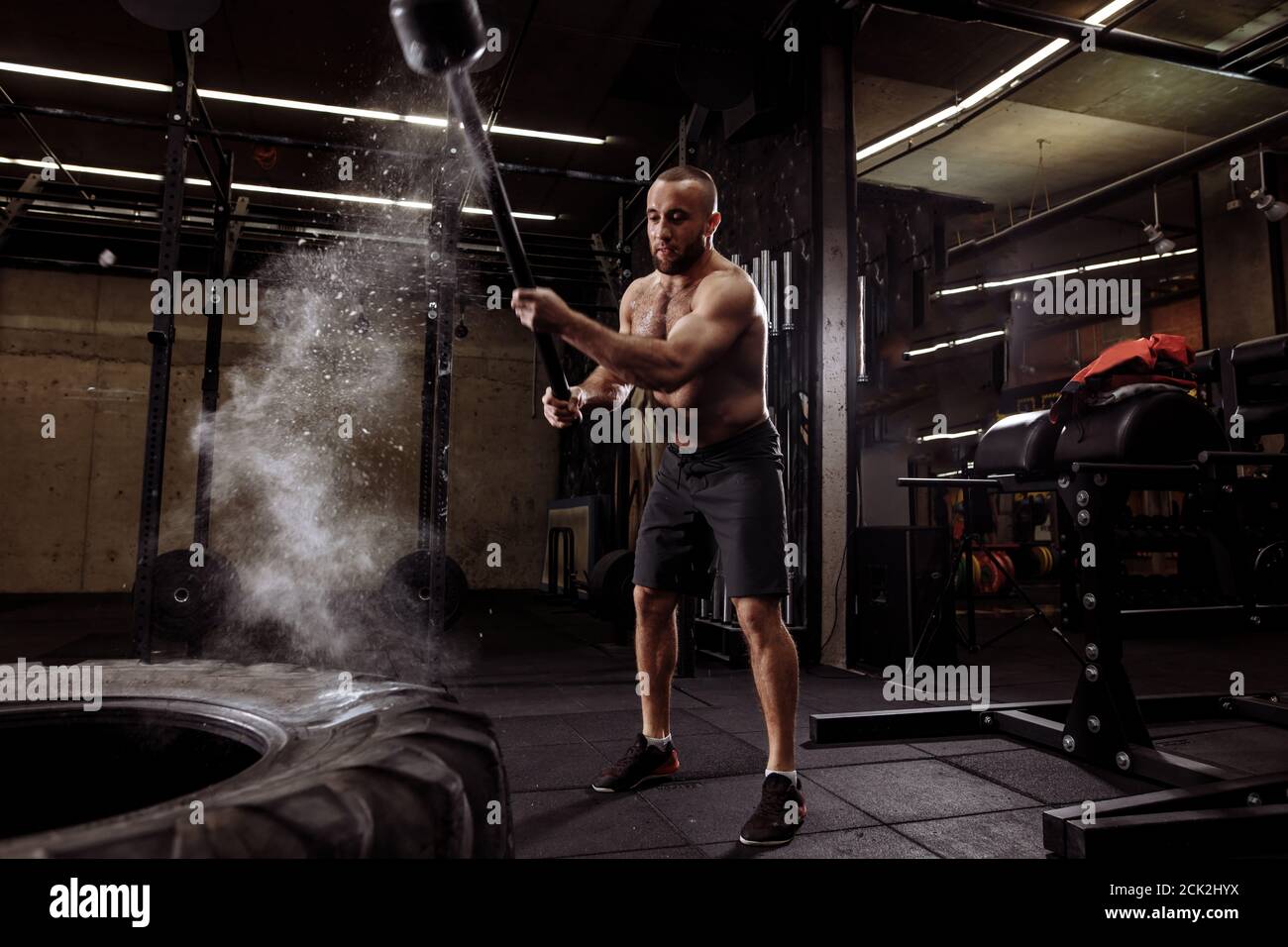 magic blow with sledgehammer.full length portrait. magnificant hit