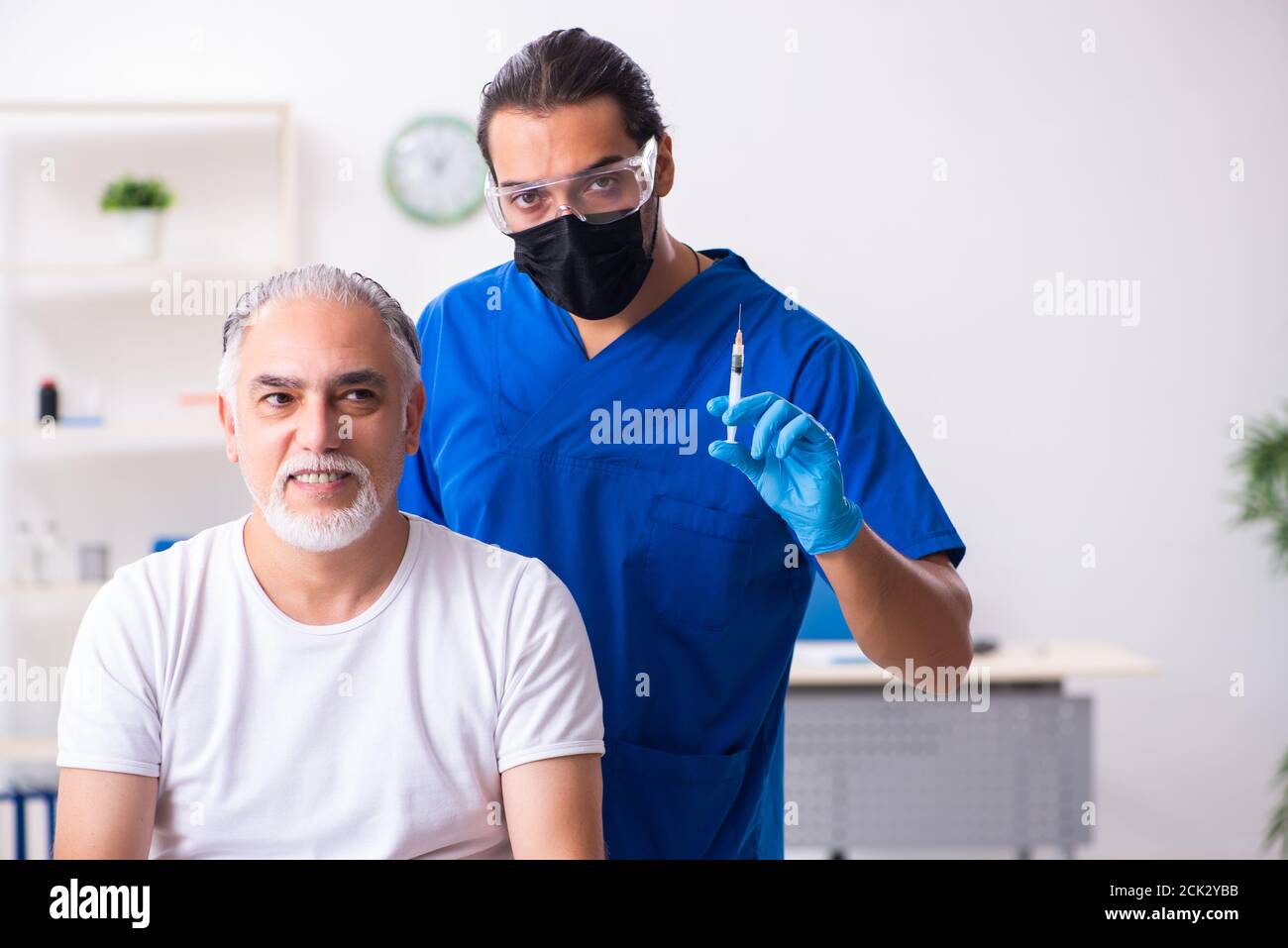 Happy mature bald man doctor hi-res stock photography and images - Alamy