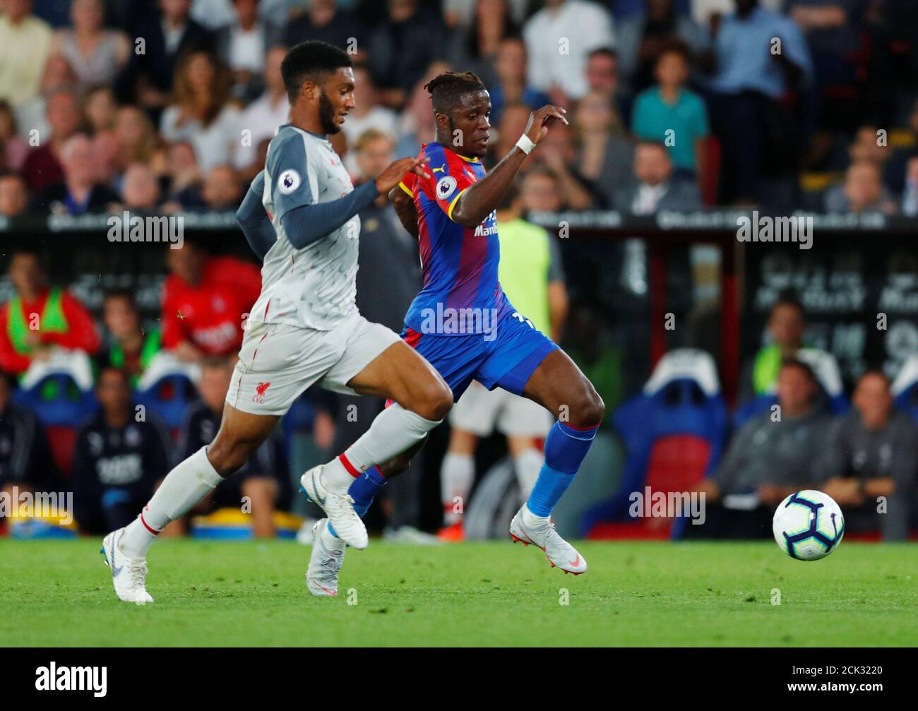 Soccer Football - Premier League - Crystal Palace v Liverpool - Selhurst Park, London, Britain - August 20, 2018  Crystal Palace's Wilfried Zaha in action with Liverpool's Joe Gomez               REUTERS/Eddie Keogh  EDITORIAL USE ONLY. No use with unauthorized audio, video, data, fixture lists, club/league logos or 'live' services. Online in-match use limited to 75 images, no video emulation. No use in betting, games or single club/league/player publications.  Please contact your account representative for further details. Stock Photo