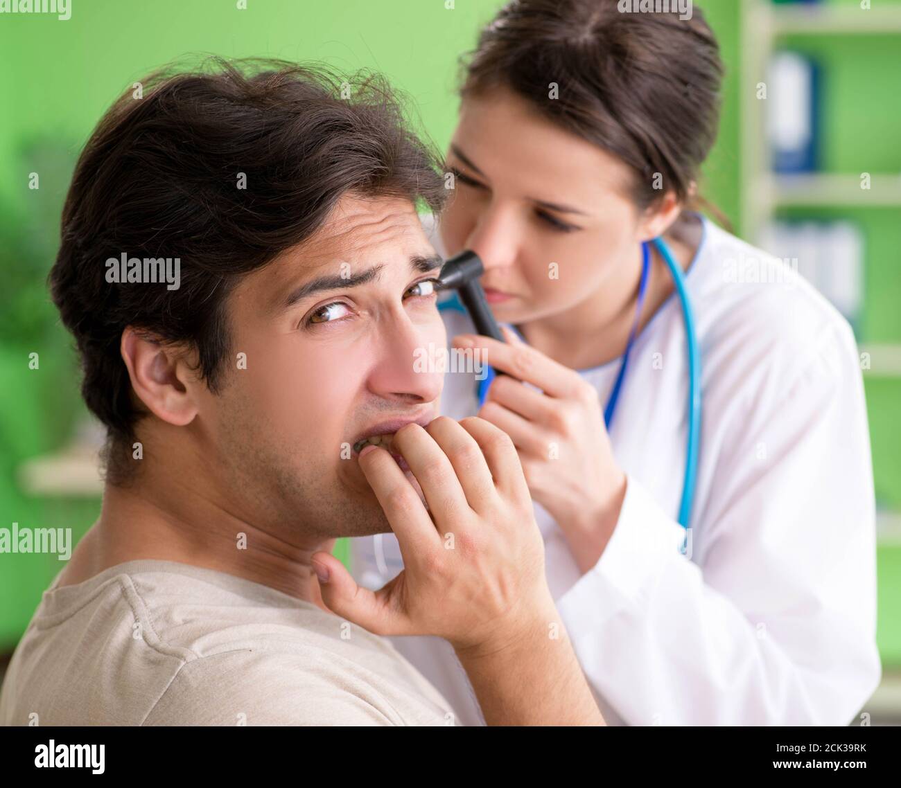 The female doctor checking patient's ear during medical examination