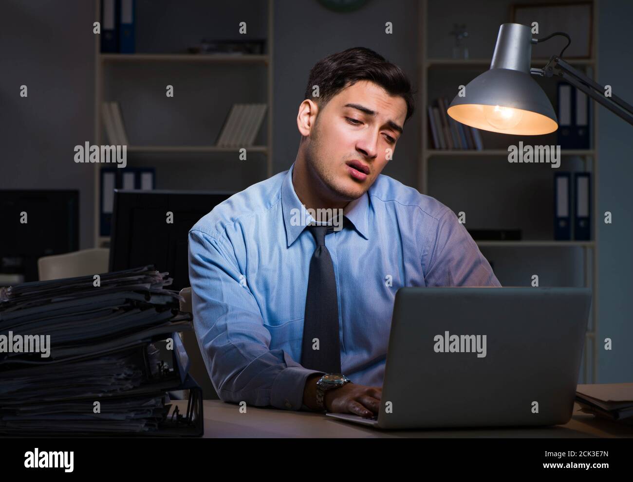 The employee working late at night at important report Stock Photo - Alamy