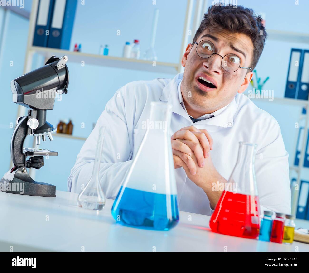 Funny mad chemist working in a laboratory Stock Photo