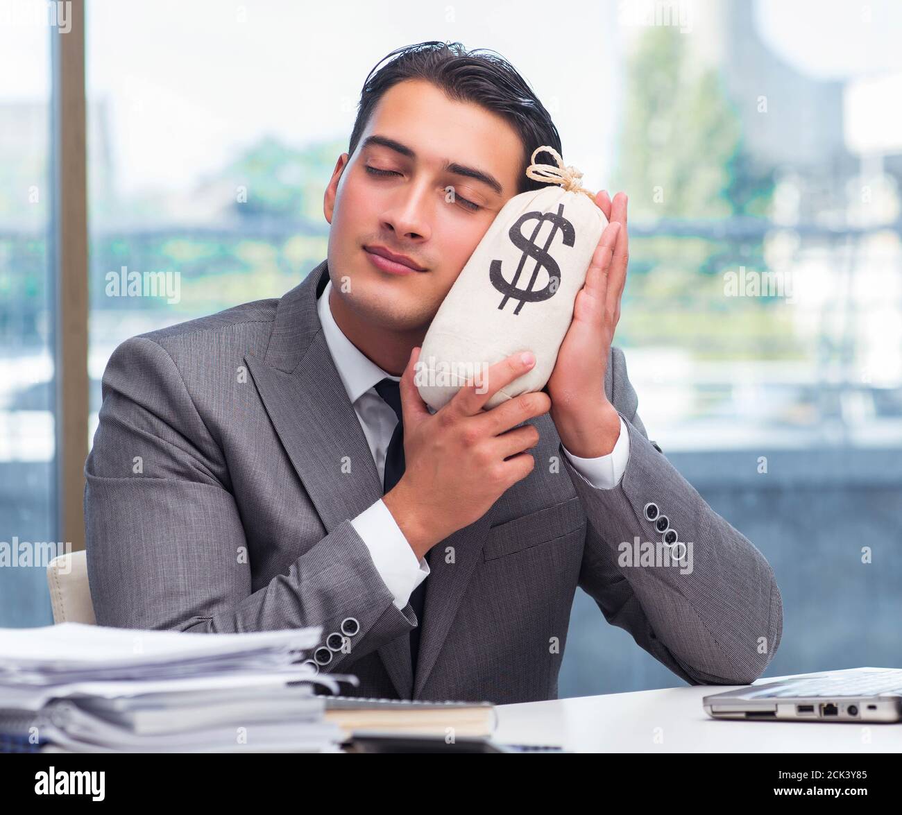 The businessman with money sack bag in office Stock Photo - Alamy