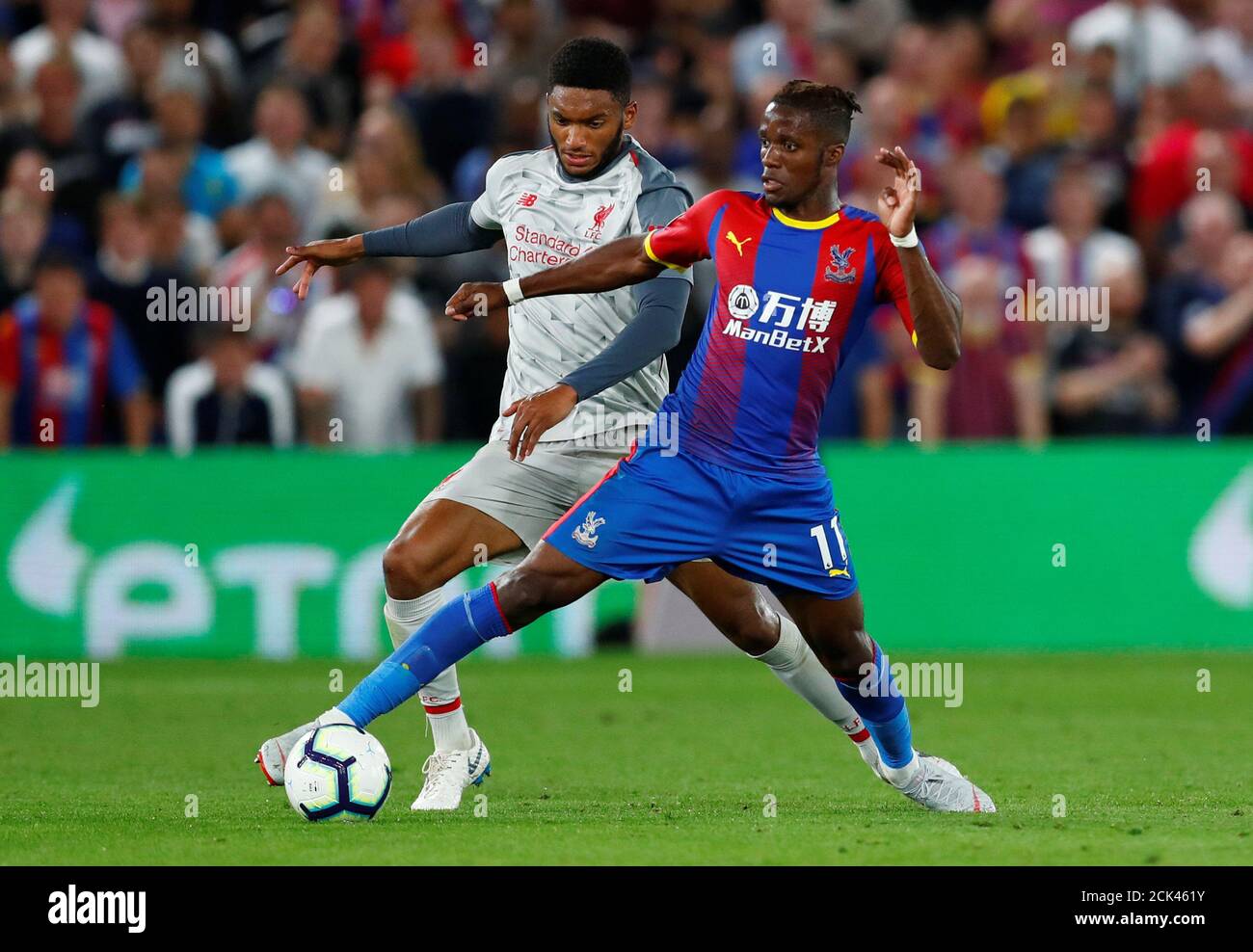 Soccer Football - Premier League - Crystal Palace v Liverpool - Selhurst Park, London, Britain - August 20, 2018  Crystal Palace's Wilfried Zaha in action with Liverpool's Joe Gomez                     REUTERS/Eddie Keogh  EDITORIAL USE ONLY. No use with unauthorized audio, video, data, fixture lists, club/league logos or "live" services. Online in-match use limited to 75 images, no video emulation. No use in betting, games or single club/league/player publications.  Please contact your account representative for further details. Stock Photo