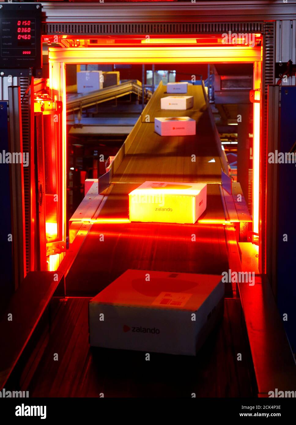 Parcels of online mail order company Zalando are transported on a conveyor  through an automatic coding device at the parcel distribution center of  Schweizerische Post (Swiss Post) in Frauenfeld, Switzerland, June 3,