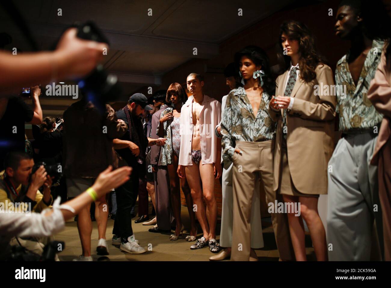 Models prepare backstage of the Edward Crutchley catwalk show at London ...