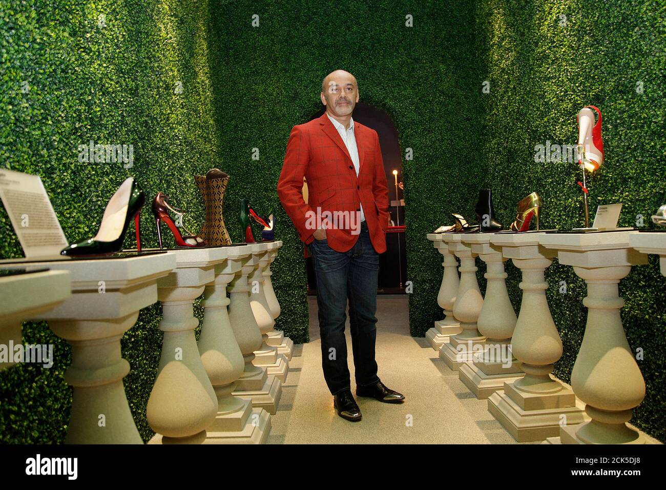 French shoe designer Louboutin poses for photographs a media viewing of his retrospective exhibition the Design Museum in London April 30, 2012. The exhibition will run from May 1