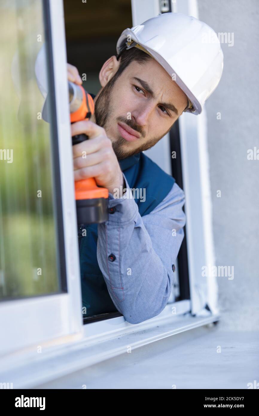 construction worker sets of metal and plastic window Stock Photo