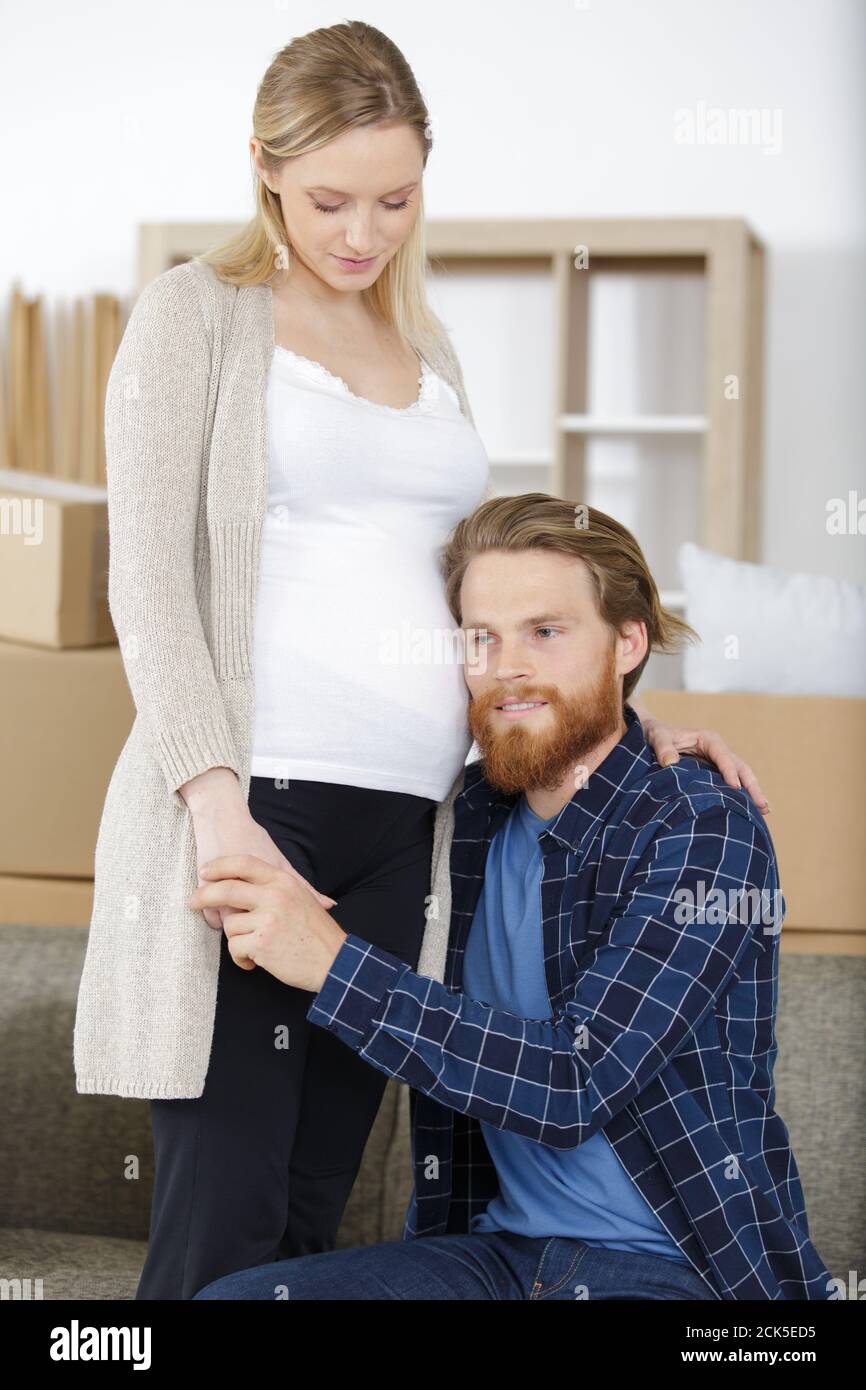 happy man listening to the belly of pregnant woman Stock Photo - Alamy