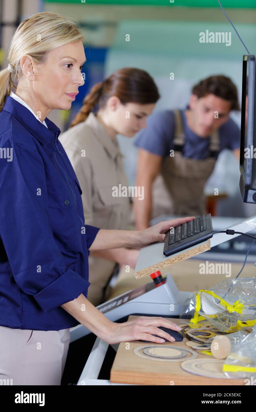 teacher in a woodwork class Stock Photo
