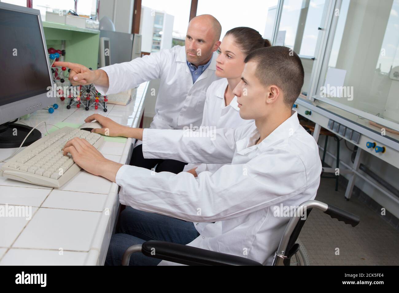 young man in wheelchair during a science class Stock Photo Alamy
