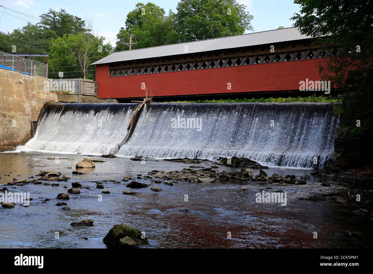 Paper Mill Village covered bridge over waterfall with Walloomsac River