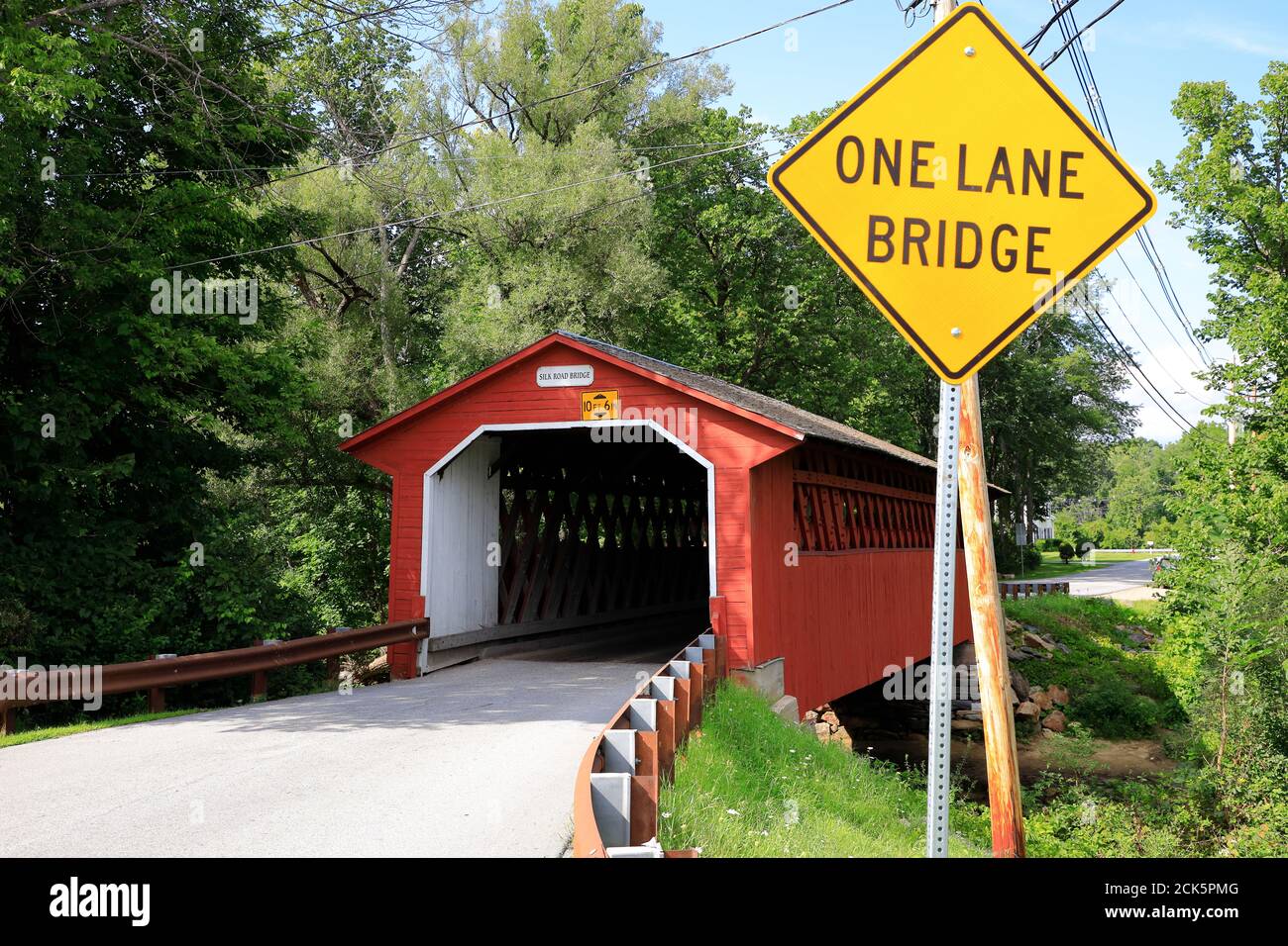 Silk Road Covered Bridge over Walloomsac River with One Lane Bridge warning sign.Bennington.Vermont.USA Stock Photo