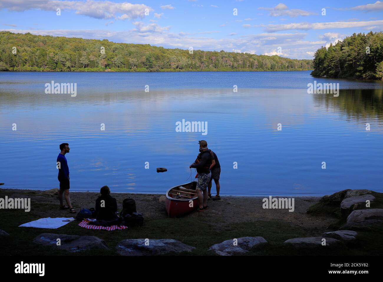 Visitors with a canoe at the boat launch.Grout Pond Recreation Area