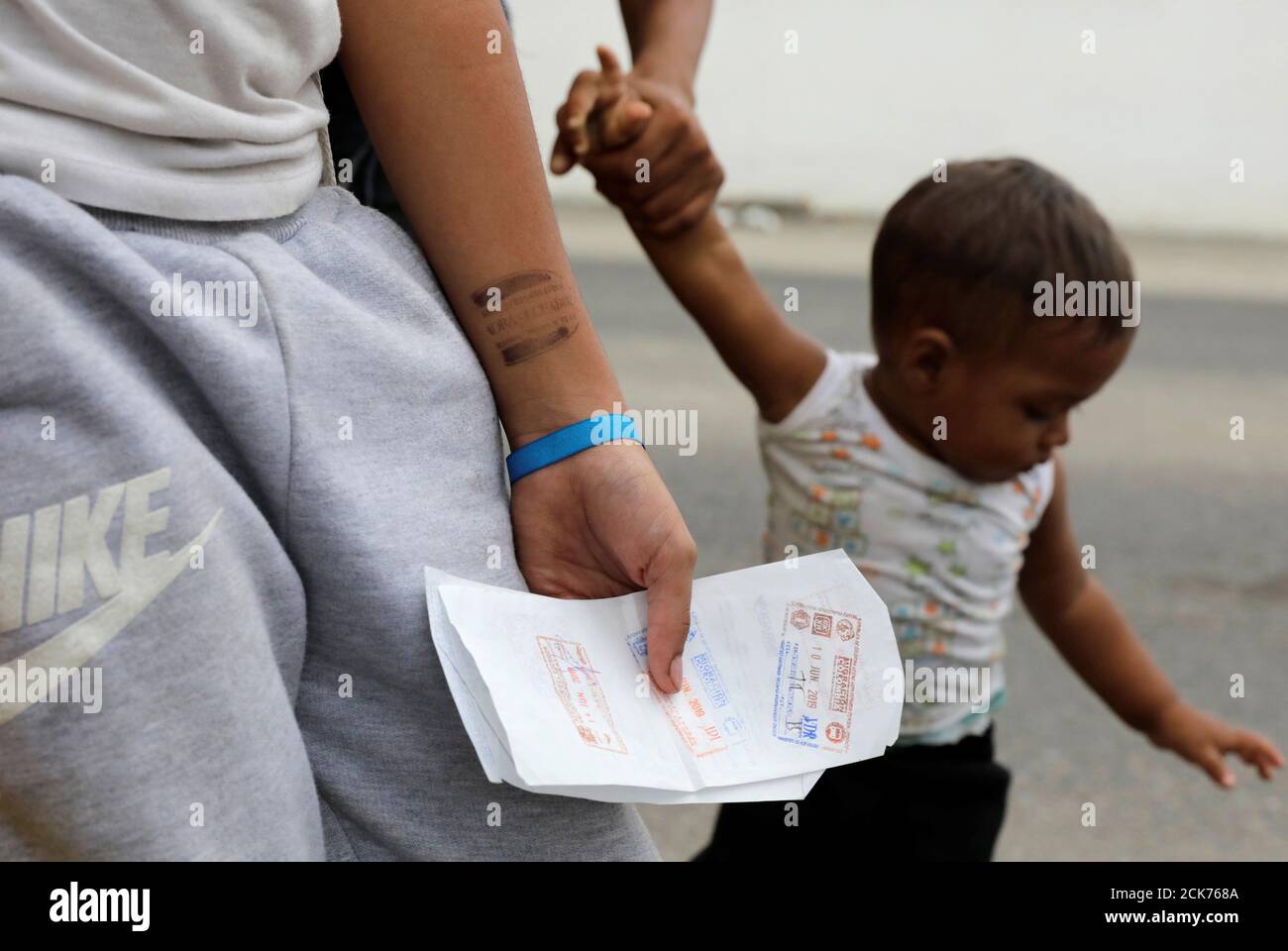 Venezuelan girl Uslady holds papers after she and her family finished immigration procedures ahead of a June 15 deadline for all Venezuelan migrants to have valid visas and passports, in Tumbes, Peru June 14, 2019. REUTERS/Guadalupe Pardo Stock Photo