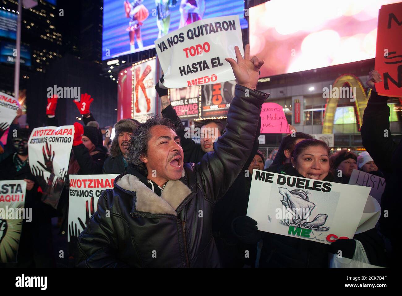 Protesters hold signs as they demonstrate against the Mexican government during U.S. President Barack Obama's speech on immigration reform, at Times Square in New York November 20, 2014. The protesters say they were demonstrating against the Mexican government on various issues such as the 43 missing Ayotzinapa students and on immigration reform. The signs read as 'We are Ayotzinapa' (L),  'They took everything from us, even fear' (C) and 'You hurt me Mexico' (R). REUTERS/Carlo Allegri (UNITED STATES - Tags: POLITICS CIVIL UNREST) Stock Photo