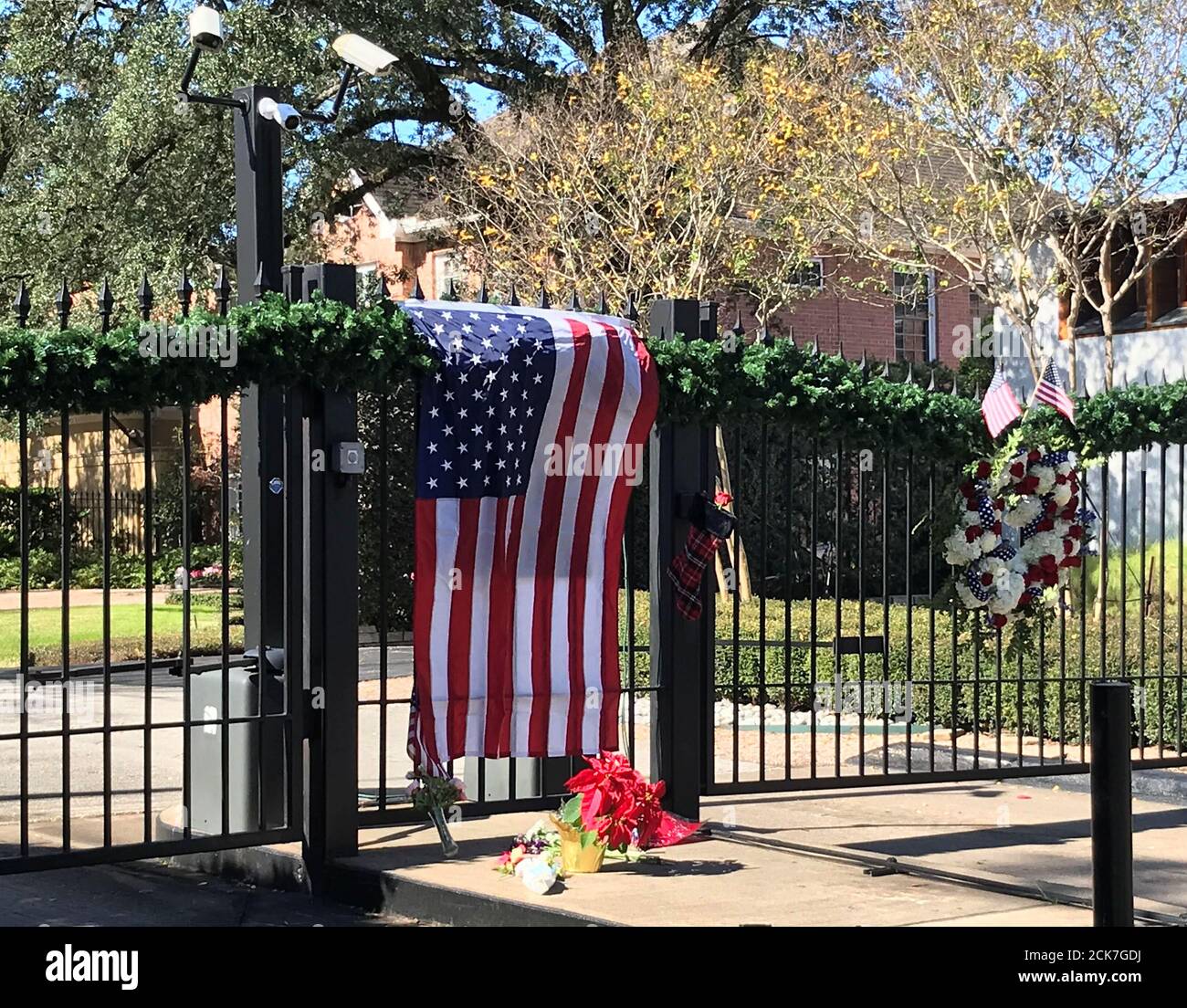 A flag is draped over the gate to the neighborhood of the home of former President George H.W. Bush, a day after he passed away in Houston, Texas, U.S. December 1, 2018. REUTERS/Gary McWilliams Stock Photo