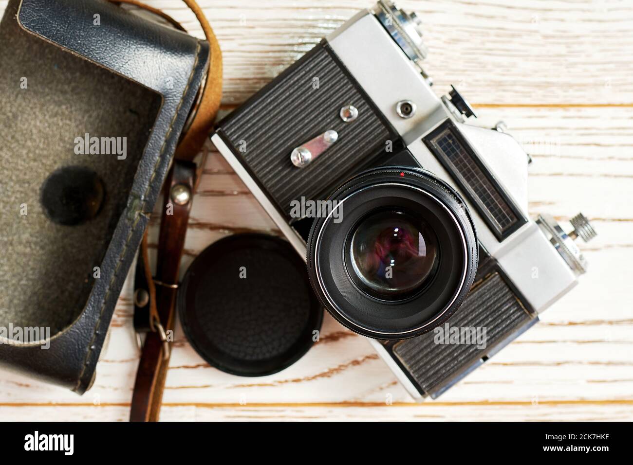 A vintage full-frame camera on the wooden surface. A revival of retro photography Stock Photo