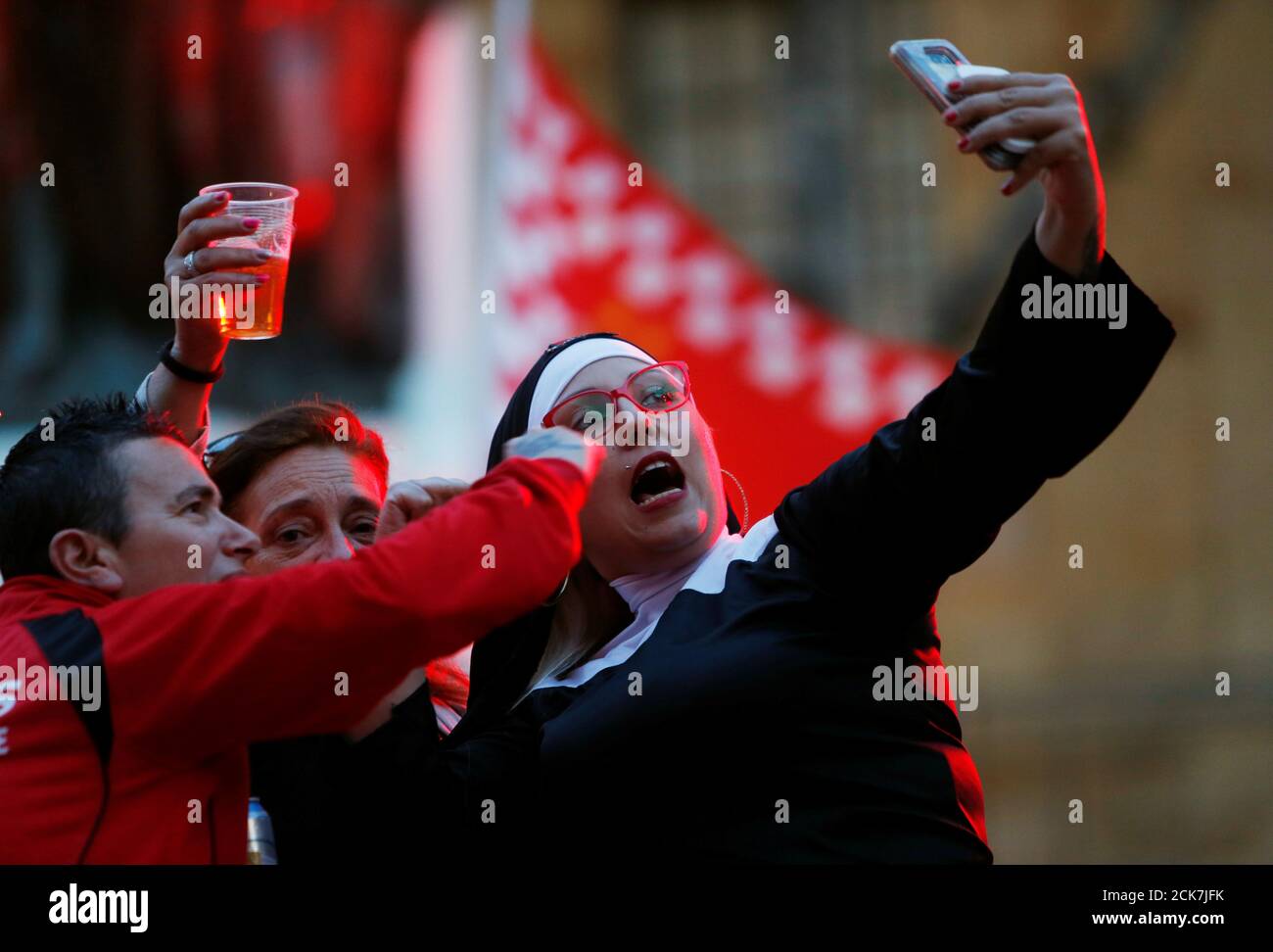 Valletta supporters take a selfie while attending a mock funeral as part of  the club's celebrations after winning Malta's premier league soccer  championship for the 25th time, during which they taunt rival
