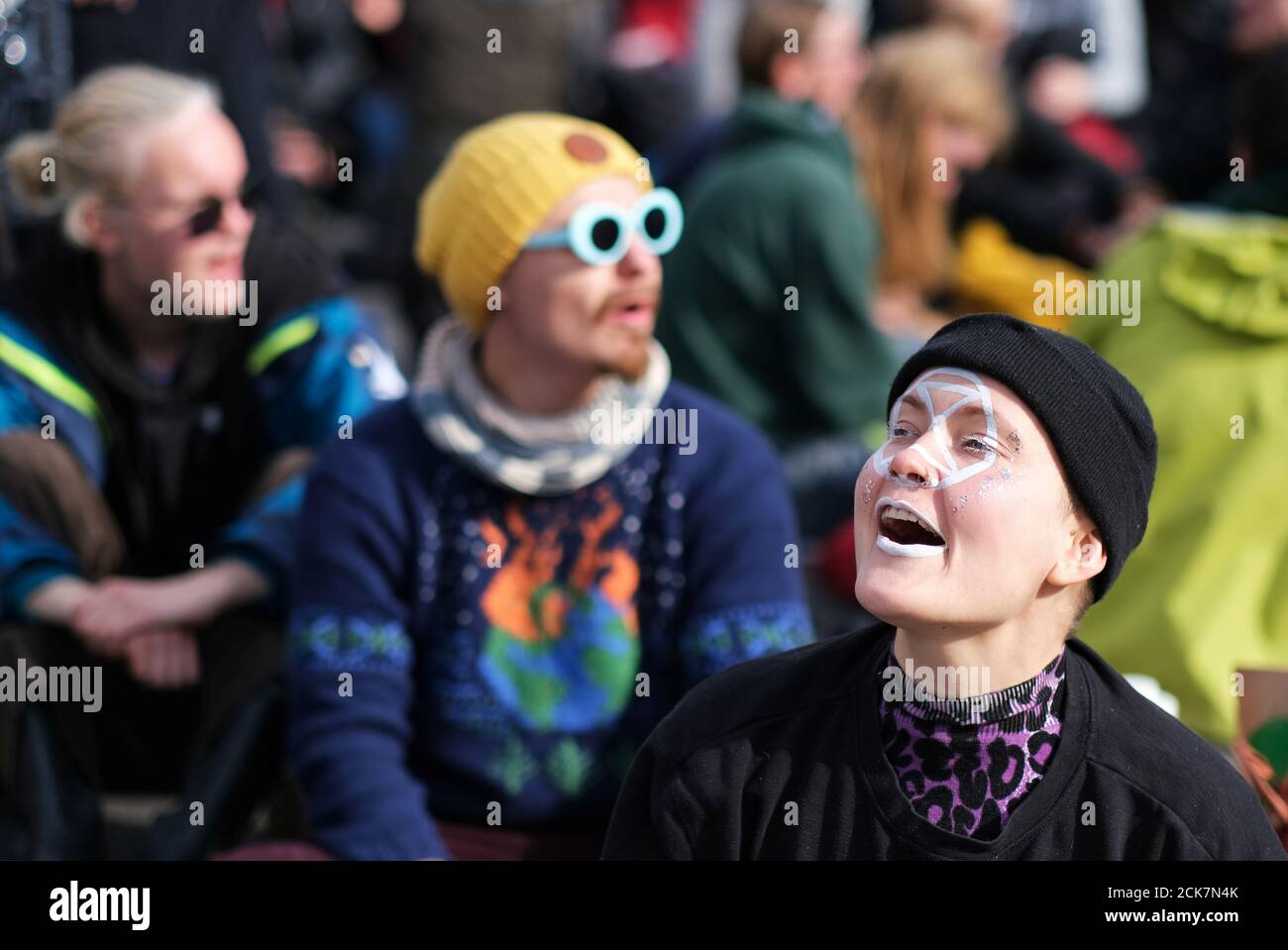 A protester with the extinction symbol painted on her face participates in the Extinction Rebellion's blockade of the Muhlendamm Bridge during the launch of a new wave of civil disobedience in Berlin, Germany October 9, 2019.  REUTERS/Christian Mang Stock Photo