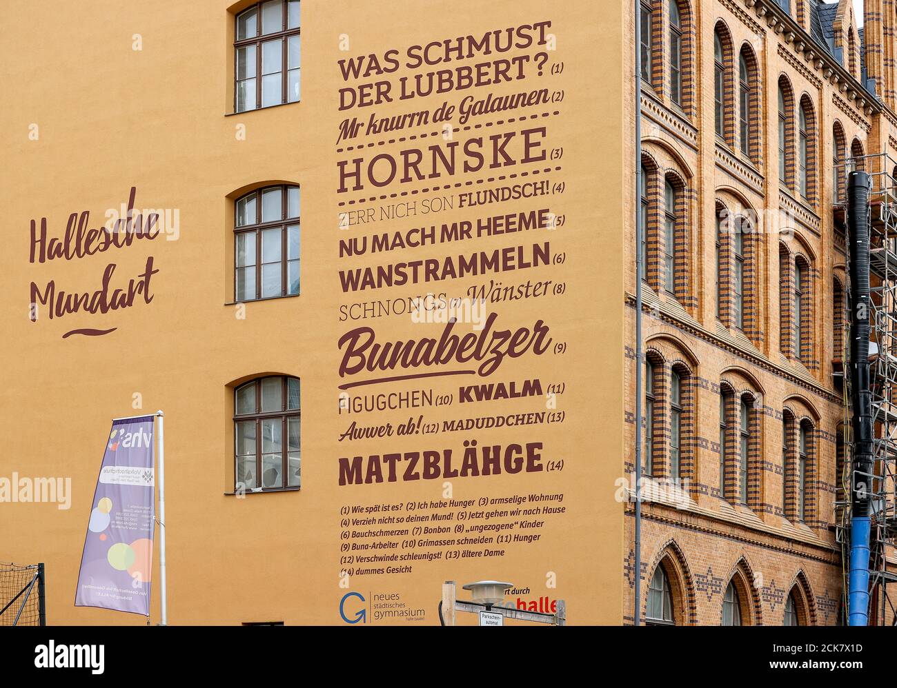 Halle, Germany. 03rd Sep, 2020. Excerpts and terms from Halle's dialect decorate a gable wall at the Lyonel-Feininger-Gymnasium. Although close to the border with Saxony, the dialects of Halle and Leipzig differ considerably. Credit: Jan Woitas/dpa-Zentralbild/ZB/dpa/Alamy Live News Stock Photo